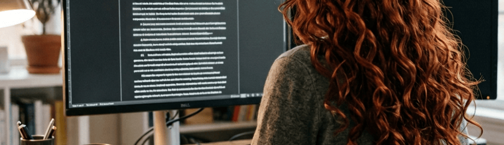 Person editing a document with tracked changes on a computer screen