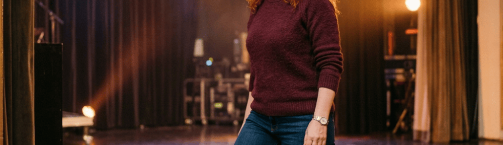 Everyday clothes, entering stage from wings